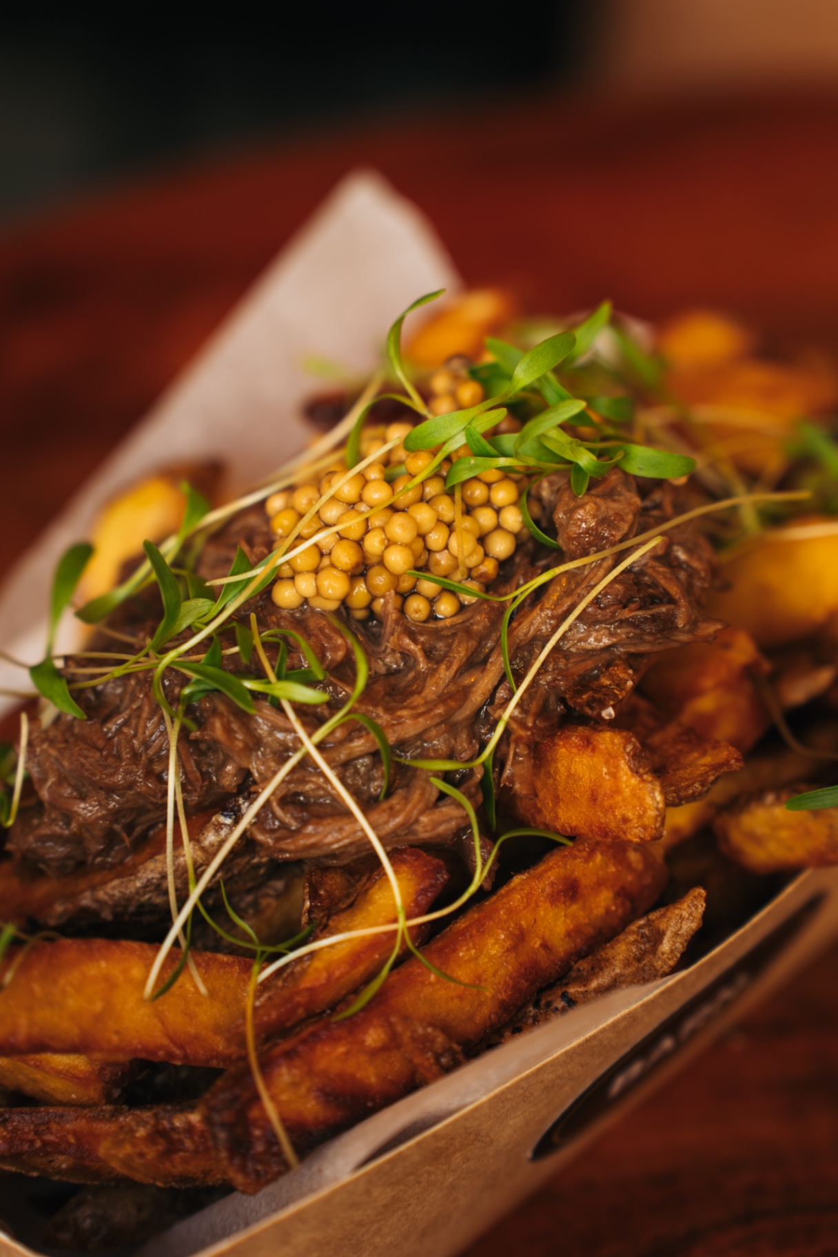 BARN. fries loaded with slow-cooked beef, pickled mustard seeds and micro herbs